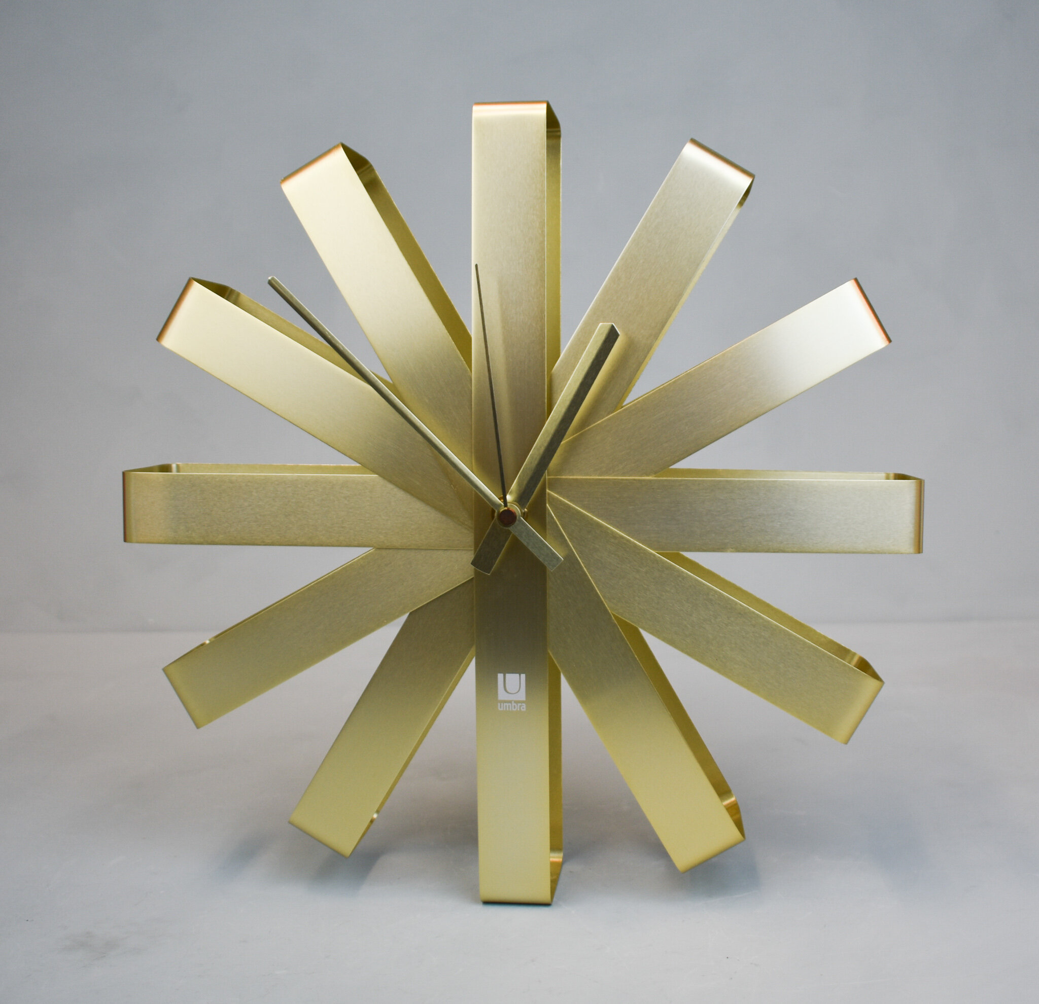 Ribbon brass wall clock, by Umbra