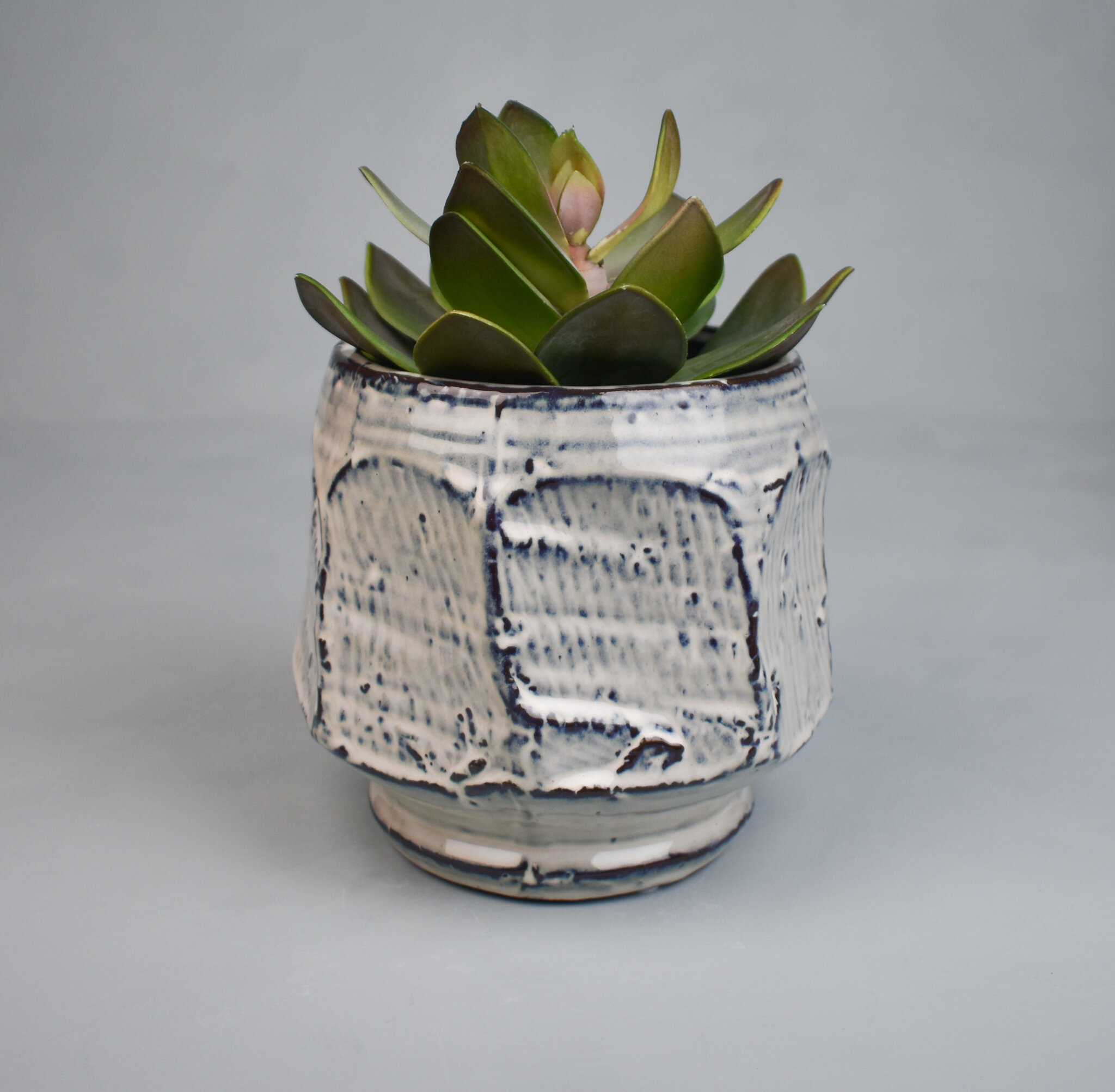 Seven-sided cream ceramic plant pot, by Bloomingville