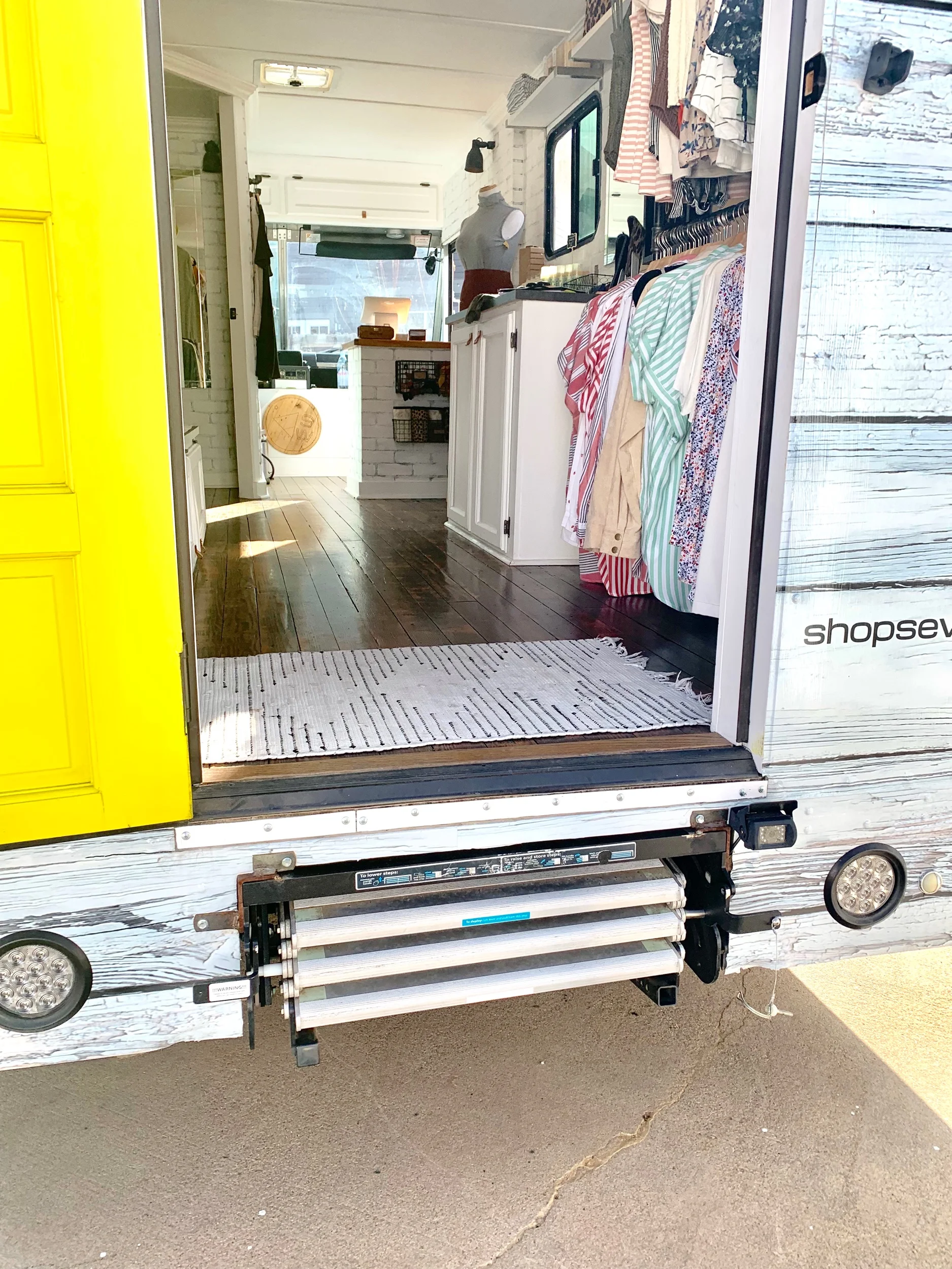 Previously a metal roll-up door without stairs, transformed by a custom-built wall complete with a real door and folding metal stairs
