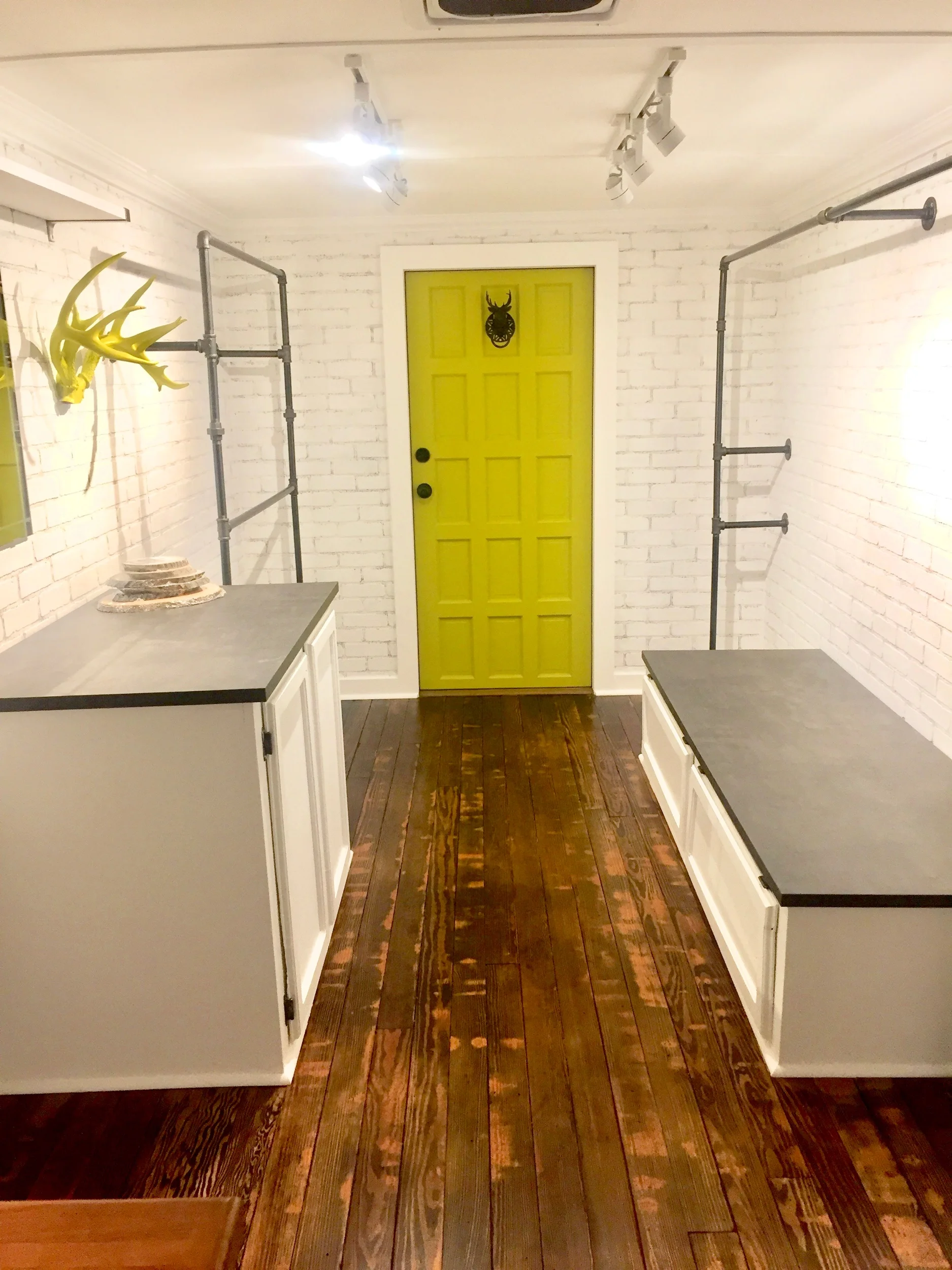 Wood floors repurposed from friend’s home remodel, refinished & custom cut to fit; battery-powered track lighting installed