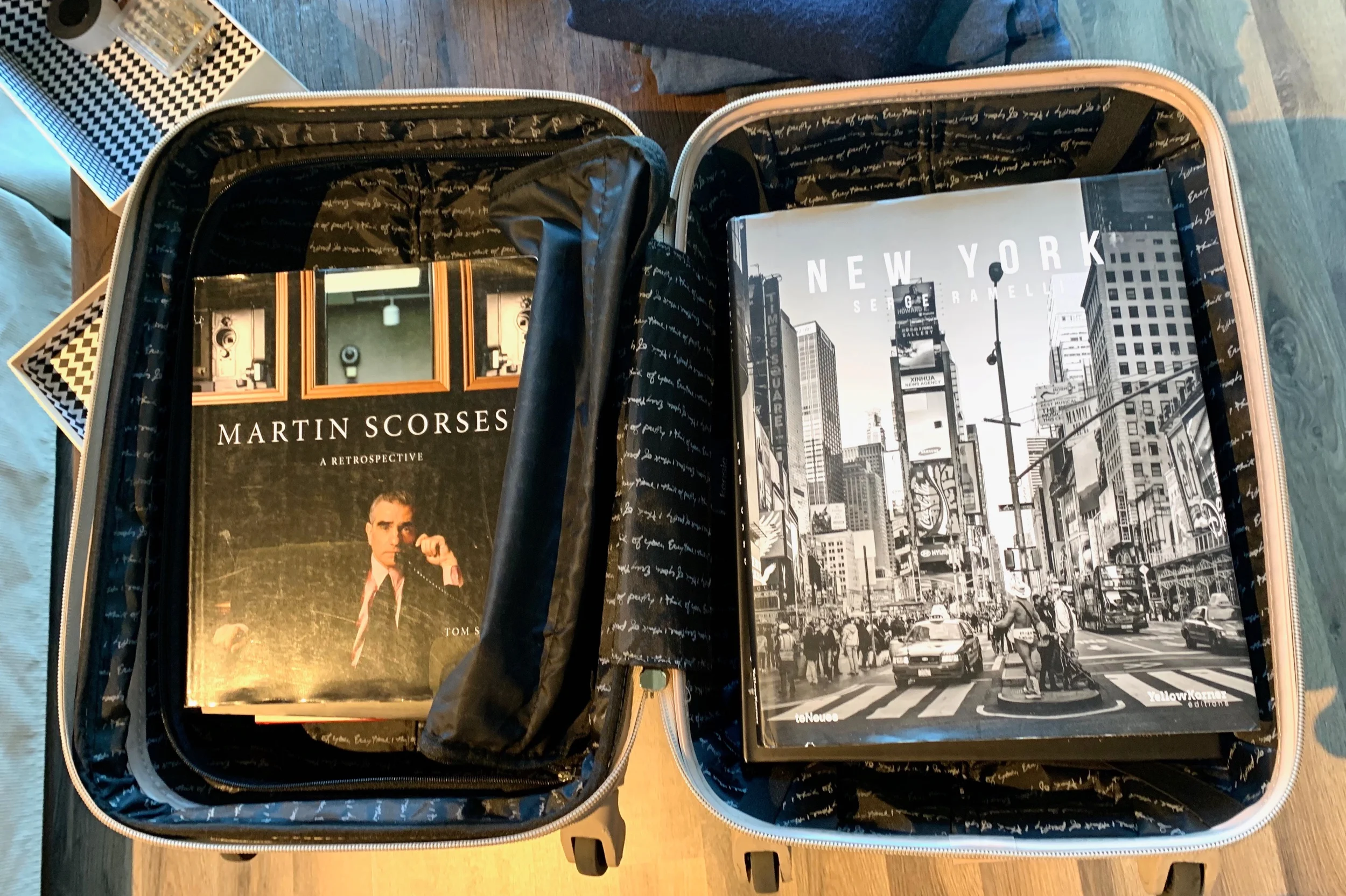 Big, heavy coffee table books often fit perfectly in a suitcase. Surround with scarves, towels, bedding or clothing to maximize the empty space…