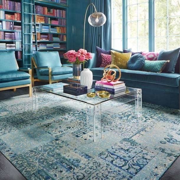 The significant presence of teal is broken up with the addition of brightly colored books and accent pillows. Courtesy of Pinterest