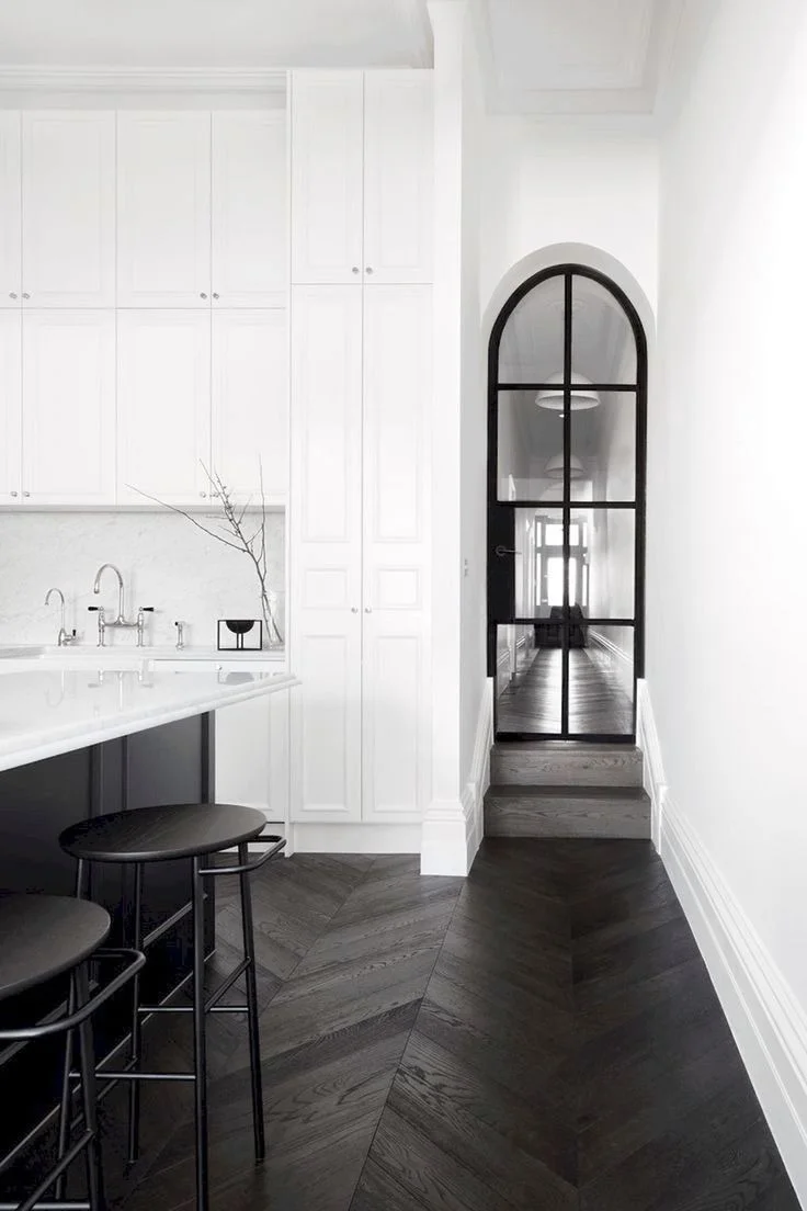 Herringbone patterned flooring creates a strong foundation and contrast against the otherwise very minimalist, modern aesthetic. Courtesy of Pinterest