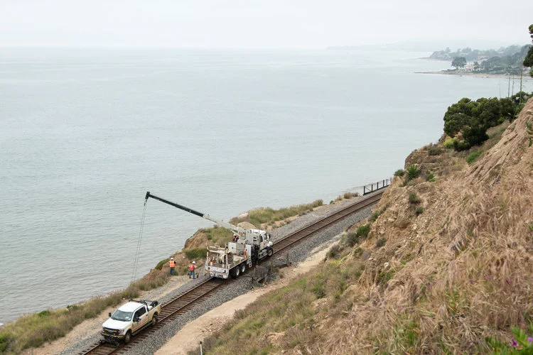 RAILROAD HEEDS HTO CALL TO RESCUE SUMMERLAND BEACH CLIFF  