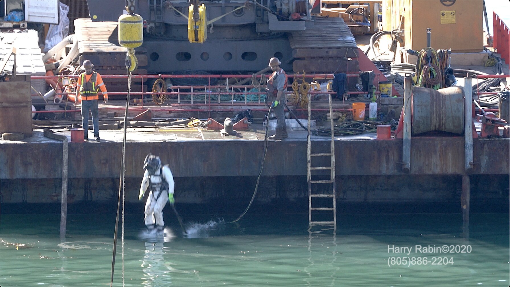  Harry Rabin captured the oilfield divers working from the Barge to prepare the NorthStar well for the  pumping of cement into the pipe encasing the well . 