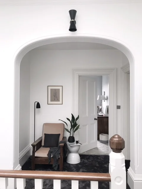 I love how Susannah has created this comfy nook on the landing with an upholstered Parker Knoll chair was passed on to her .