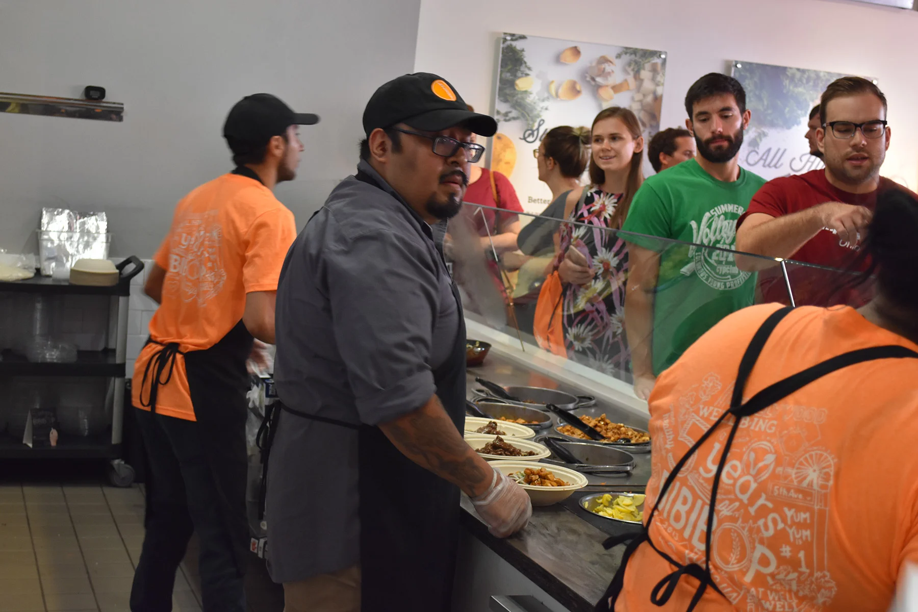 Store general manager and his staff members wearing their orange