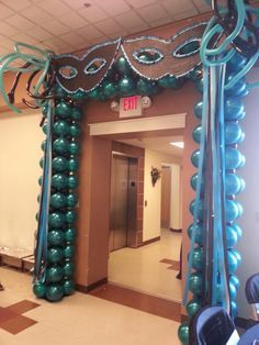  Clever placement of balloons here has transformed this entrance into gigantic matching masks with a pearl drape 