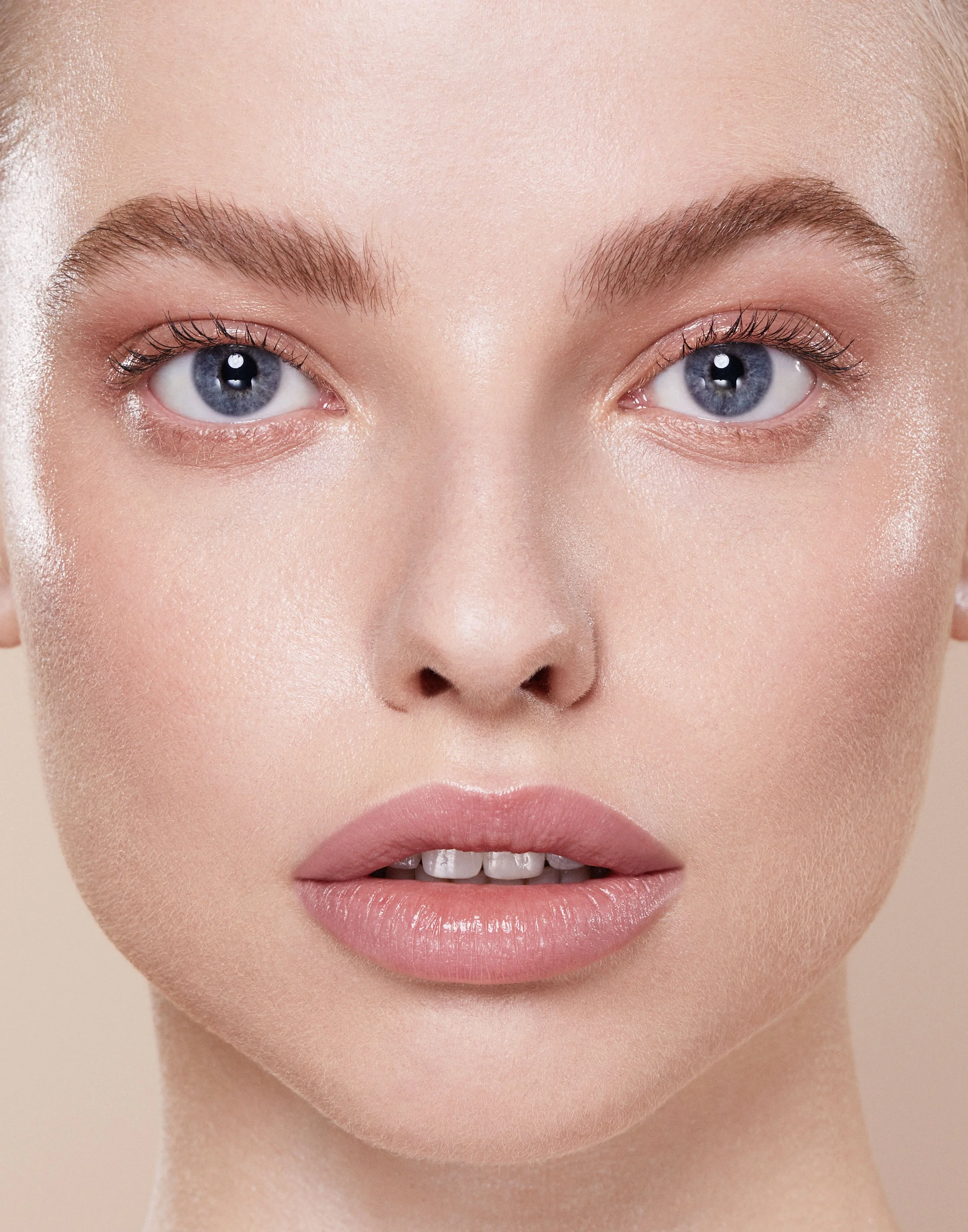   The makeup look features a soft, ethereal glow that enhances natural beauty while adding a hint of drama. A dewy foundation creates an impeccable canvas, allowing the skin to breathe while maintaining a luminous finish. The eyes are accentuated wit
