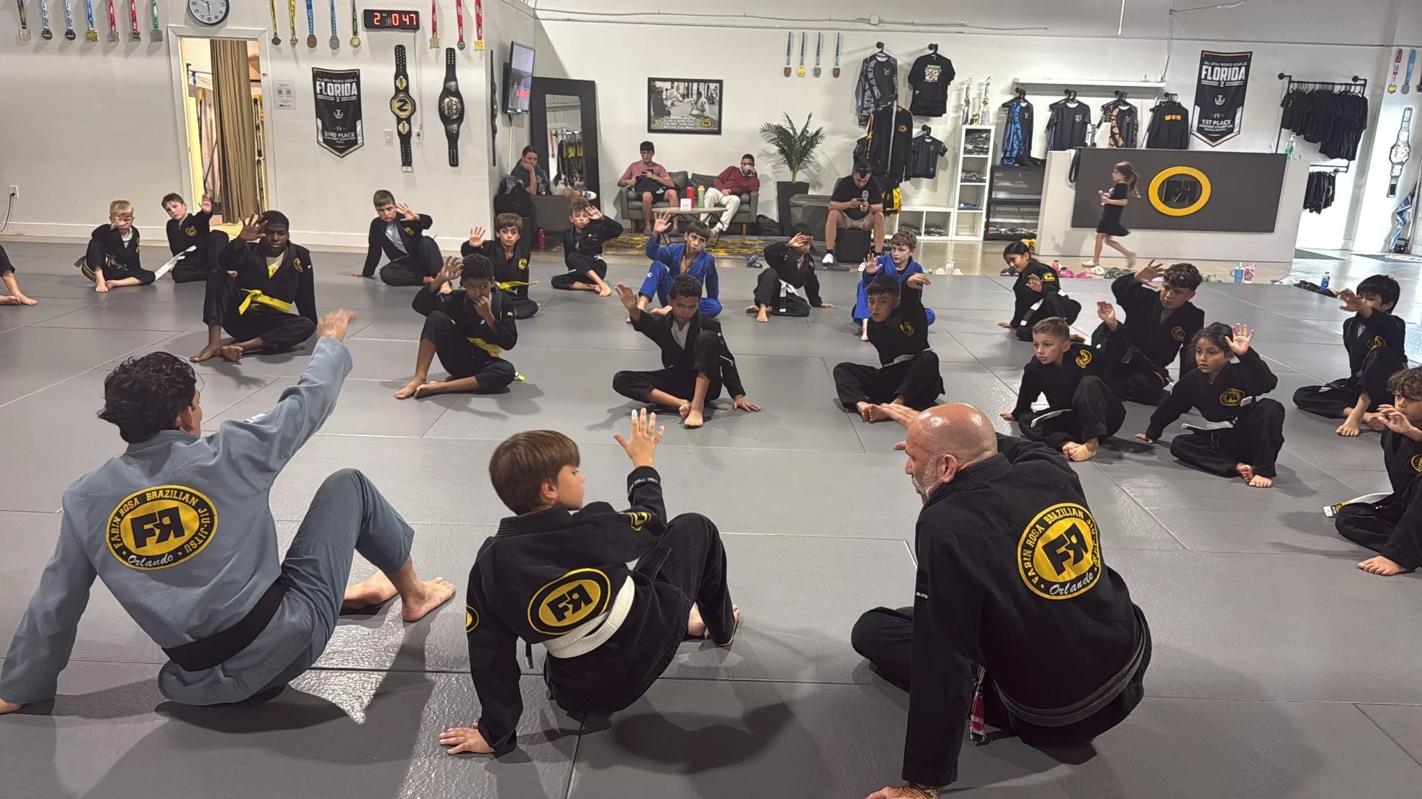 Kids and instructors practicing jiu-jitsu at FRBJJ Lake Nona