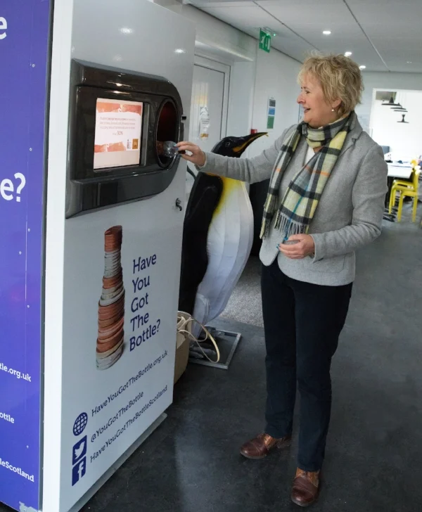 Roseanna Cunningham, Cabinet Secretary for Environment, Climate Change and Land Reform, trials a reverse vending machine at Edinburgh Zoo.