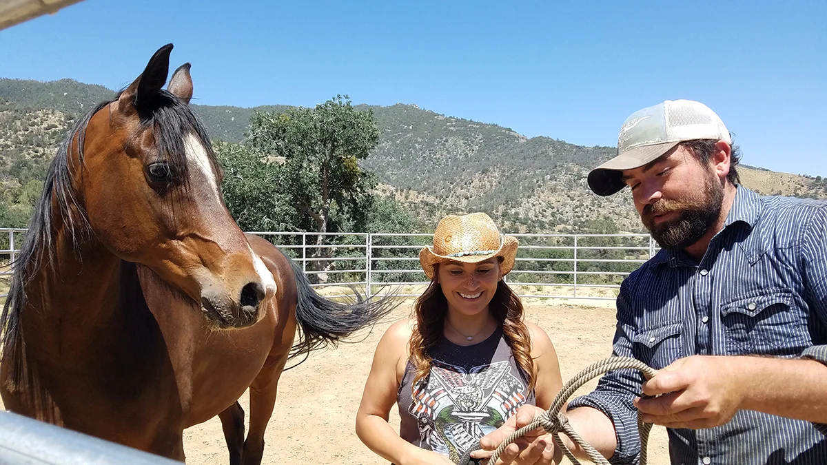 Clay (one of our equine instructors) is showing our veteran, Luz, how to halter a horse for the first time.