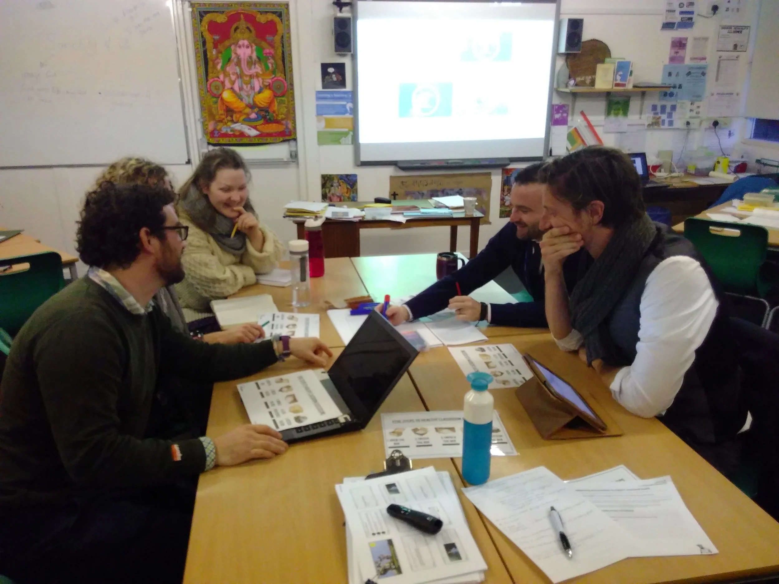 Staff discussing the ThoughtBox Five-Step approach to healthy classroom discussions. 