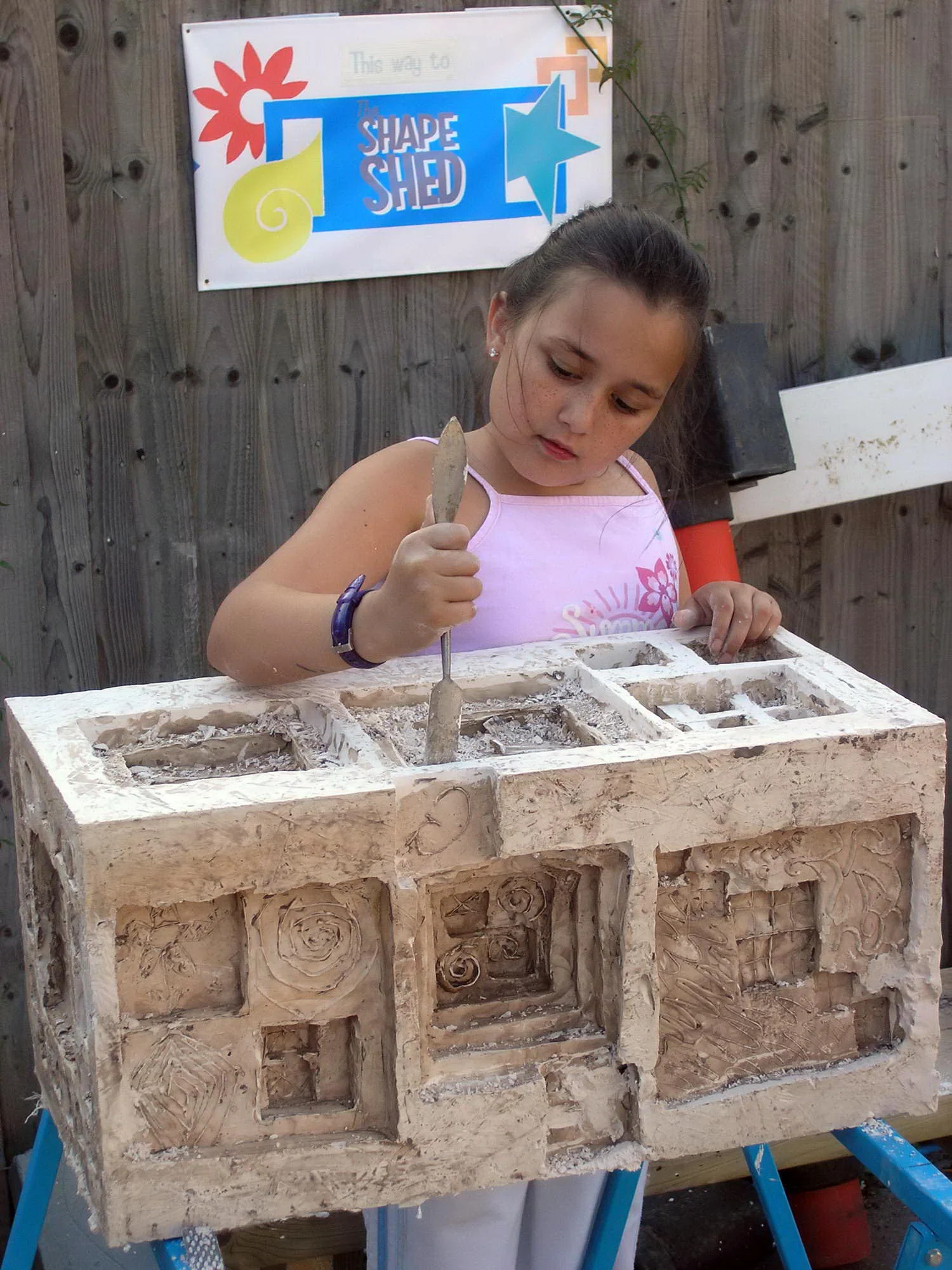 Removing clay from the cast plaster block.
