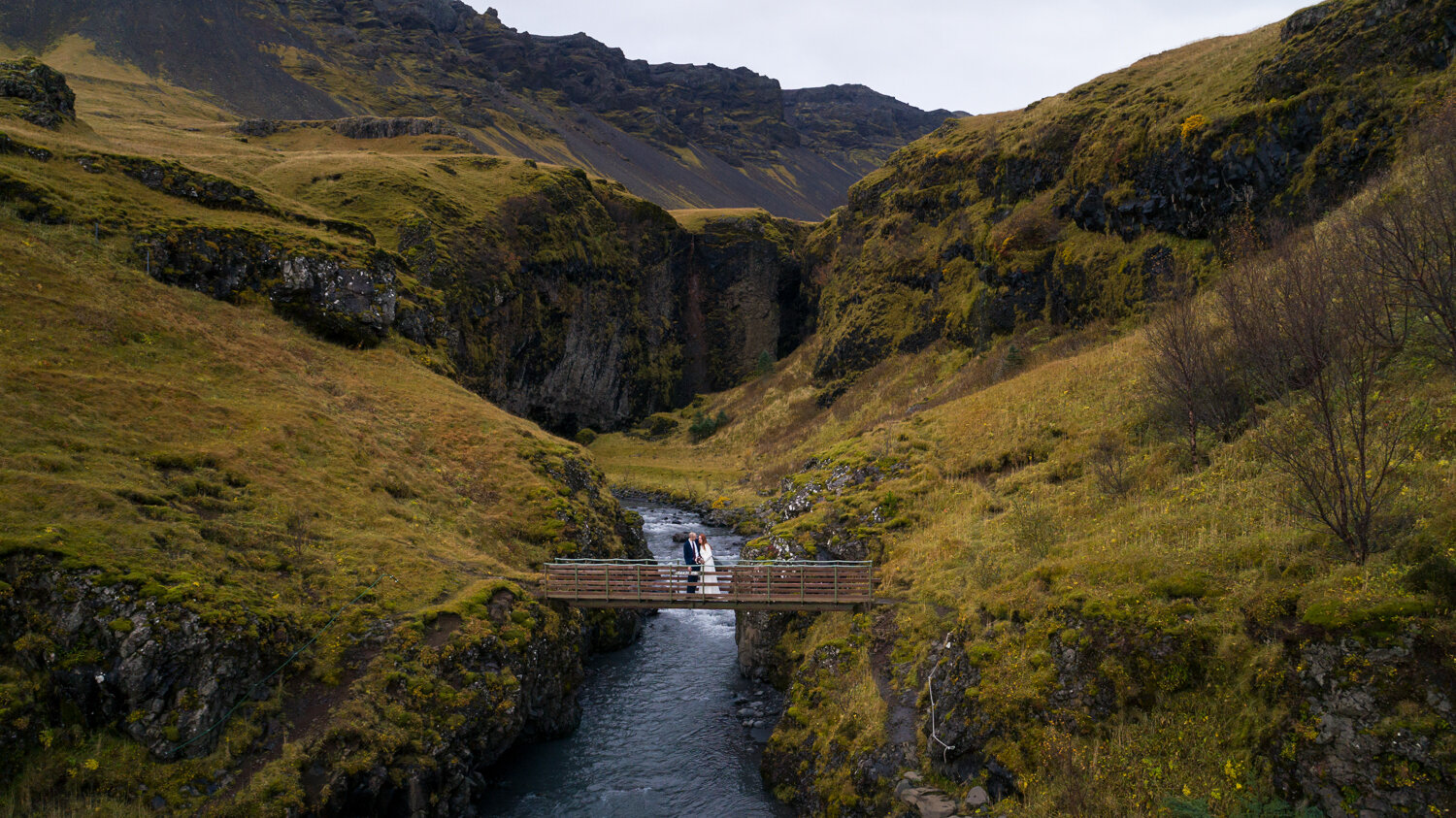 Iceland pre wedding photographer. Drone pre wedding photography of a couple on bridge in a canyon in south coast of Iceland.
