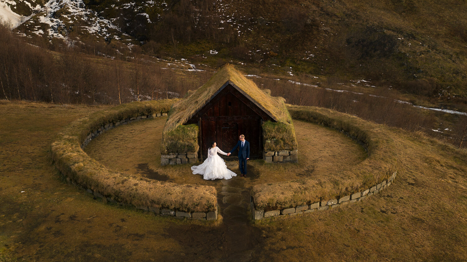 Iceland wedding photographer. Drone wedding photography next to a traditional Icelandic sod grass roof house.
