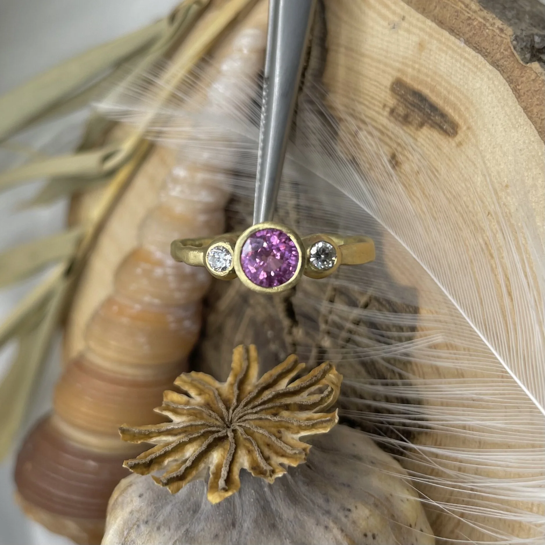 Pink sapphire and diamond three stone engagement alternative bridal ring set in 18ct yellow gold matte finish by Erin Cox Jewellery molten style handmade handcrafted jeweller Exeter Topsham Devon