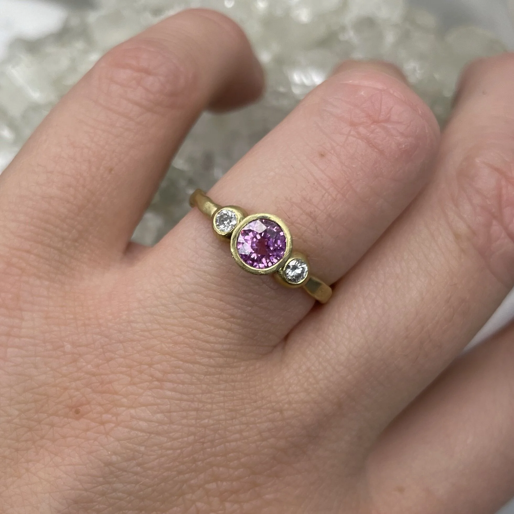 Pink sapphire and diamond three stone engagement alternative bridal ring set in 18ct yellow gold matte finish by Erin Cox Jewellery molten style handmade handcrafted jeweller Exeter Topsham Devon