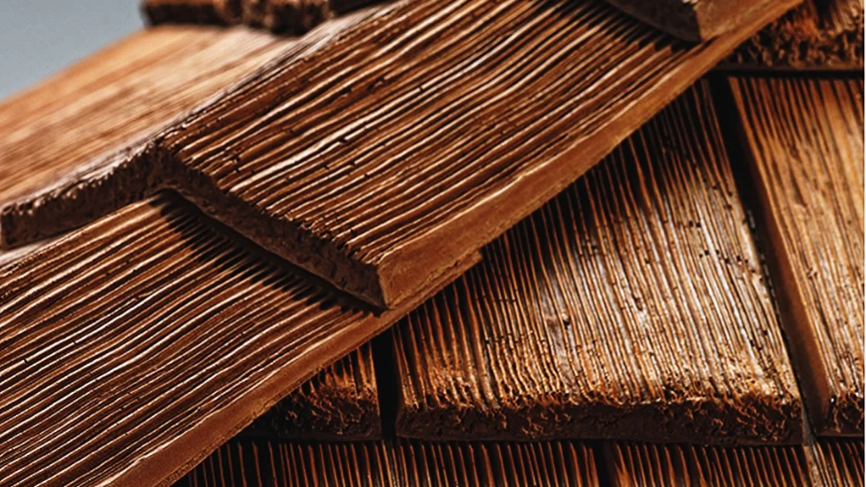 Close-up view of CeDUR synthetic shake shingles showing detailed wood-grain texture.