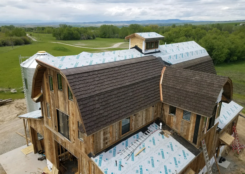 Walden roof installation on a home with a gambrel roof design under construction.