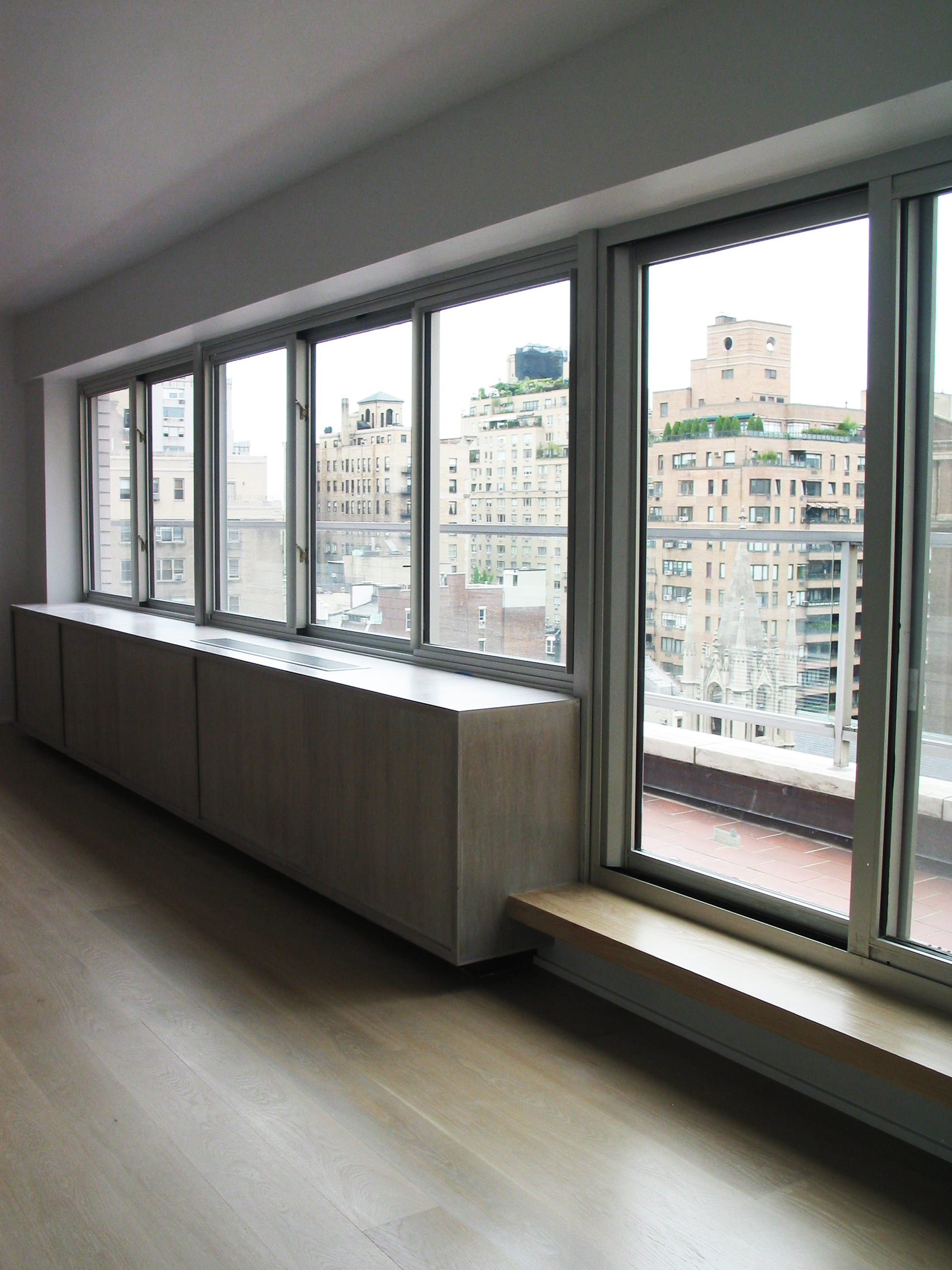 UPPER EAST SIDE WHITE BRICK - 2008 The project objective was to return this apartment in a 1950’s "white-brick" building back to its late-modernist style and integrity, using a minimalist white on white simplicity. The gut renovation also included opening the exterior wall up for a continuous run of windows and doors, which required some deft maneuvering through the Landmarks Commission.