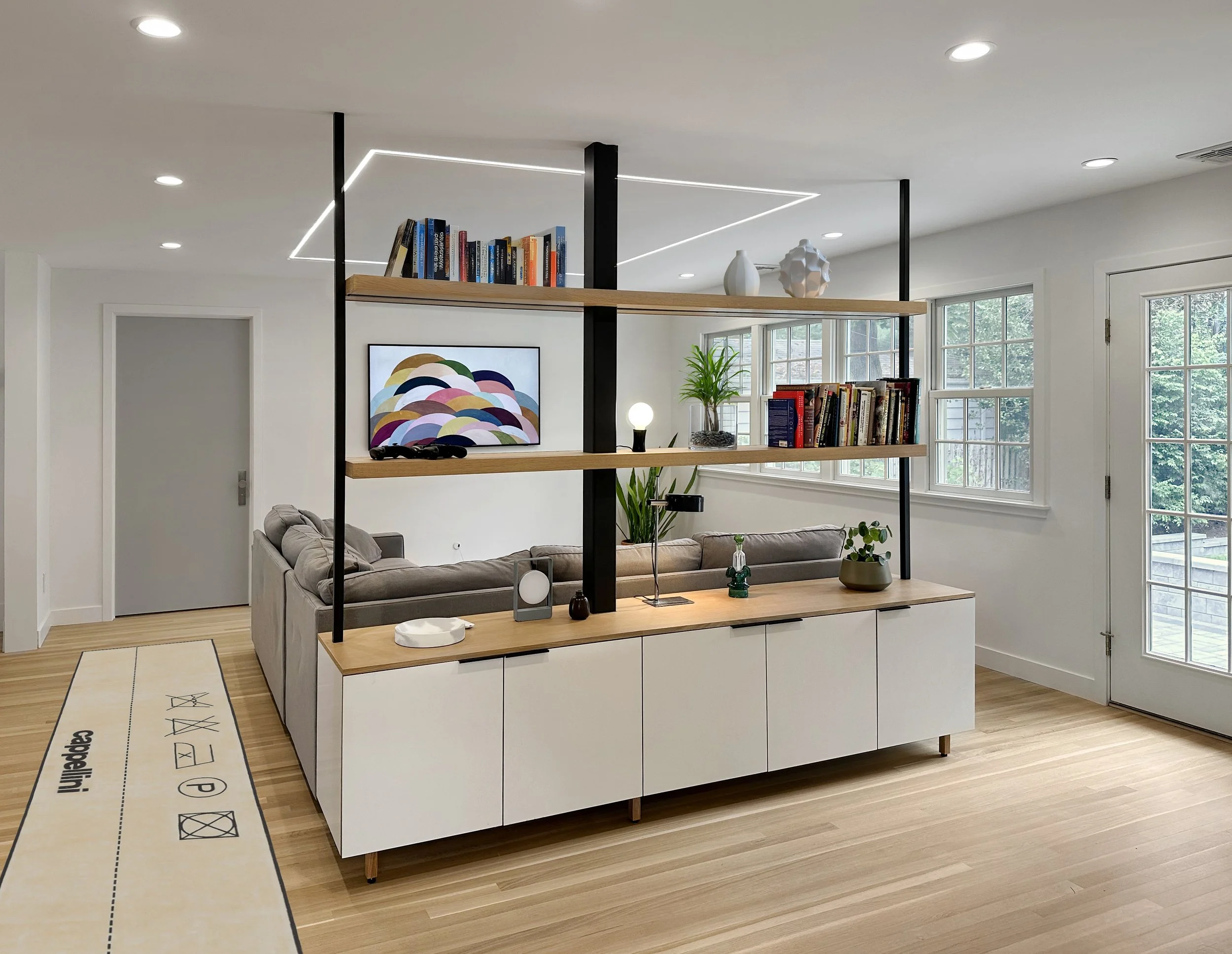  the house had an awkward, bulky structural column, and an odd shaped living rm that was reducing vital space,  and the client’s just couldn’t abide.  we came up with a great solution - replacing the column with a slender steel post that gets integra