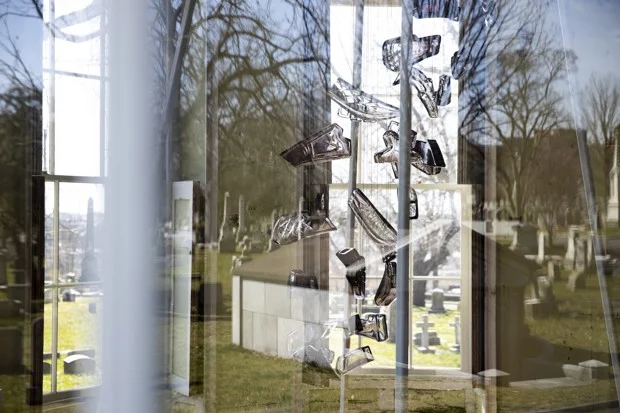 Meier’s article included this photograph of Leo Tecosky’s installation viewed through a window, reflecting the surrounding cemetery at The Woodlands. Photo by Ryan Collerd.