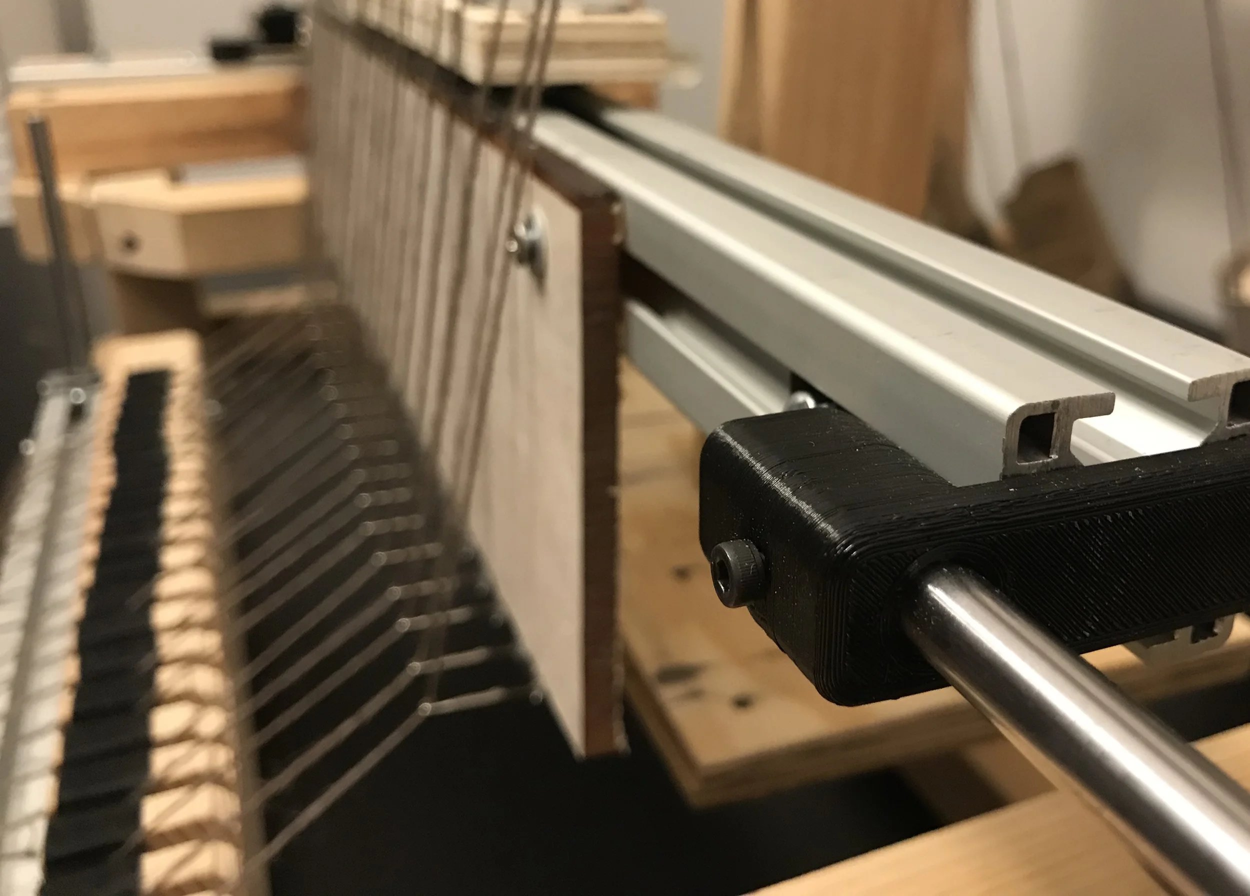 I designed 3D printed inserts to attach the extruded aluminum to the linear shafts.