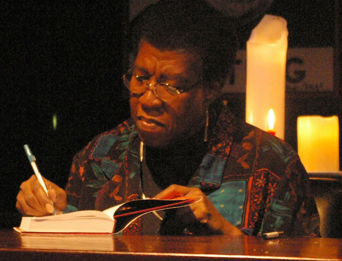 Octavia E. Butler signing a copy of her book Fledgling. Photo credit: Nikolas Coukouma