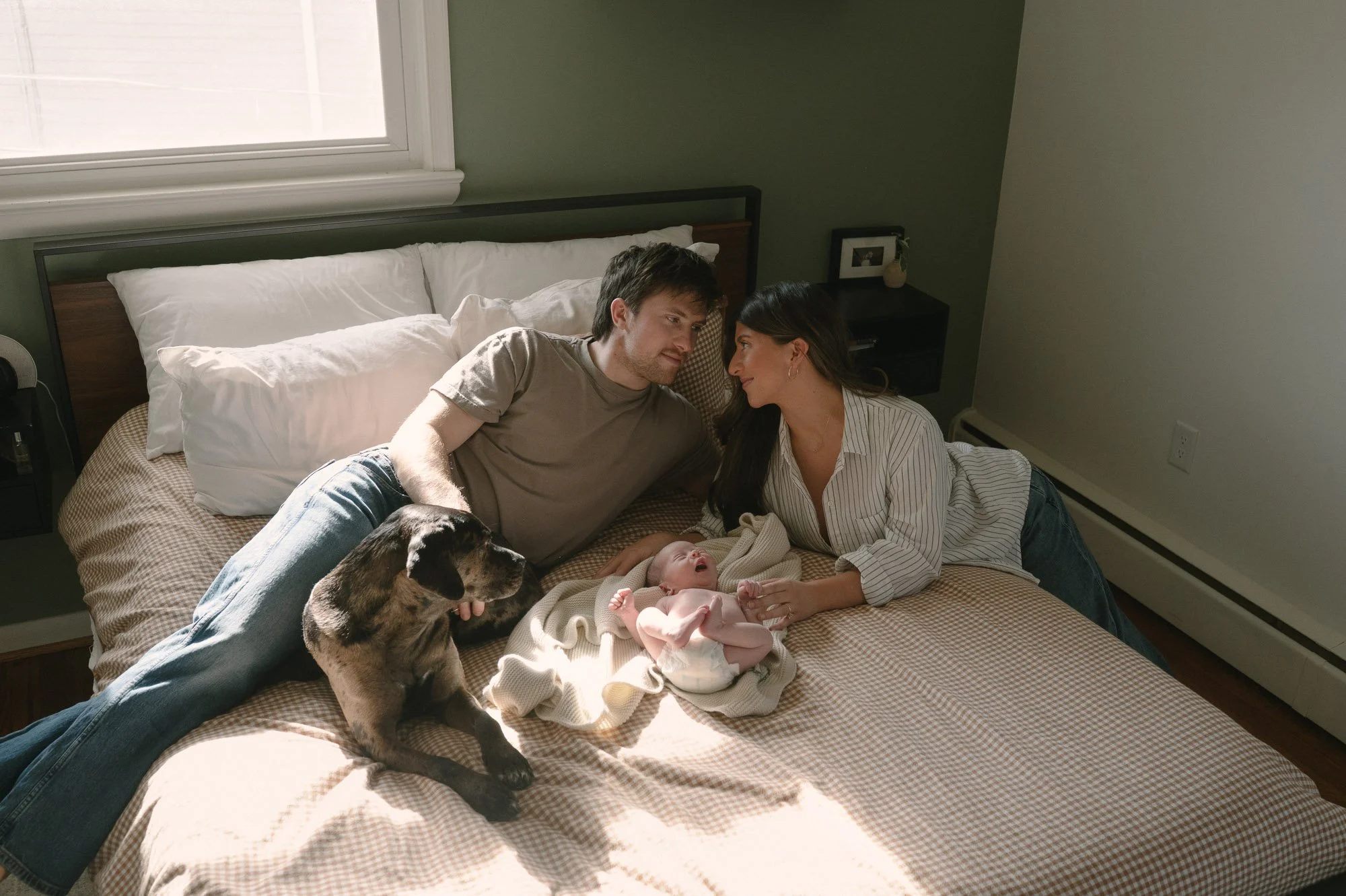 Family with newborn baby during a photoshoot celebrating baby's birth