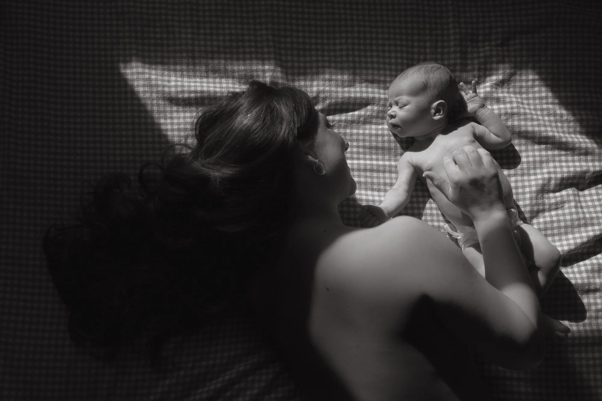 Mother with newborn baby during a motherhood in-home session in Potomac Maryland