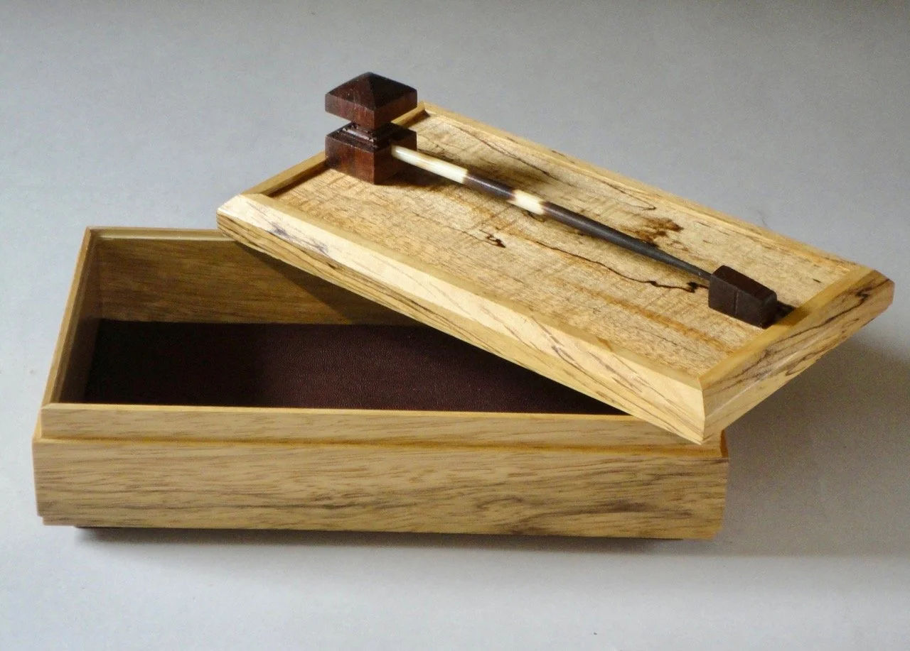  Letters from Africa , Matthew X. Curry,  African porcupine quill, contrasting wood details, spalted figured maple, black limba and Cordoban leather liner,  9.75” x  5.5” x  4.5” $680                     ‍ 