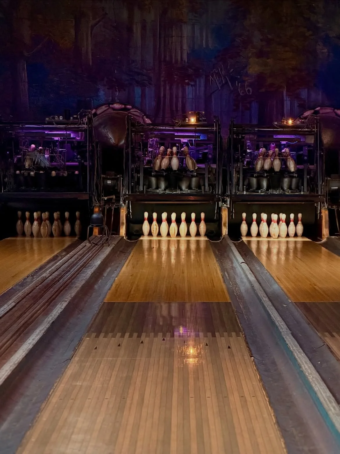intage bowling lane with polished wood floors and standing pins inside the historic Highland Park Bowl.