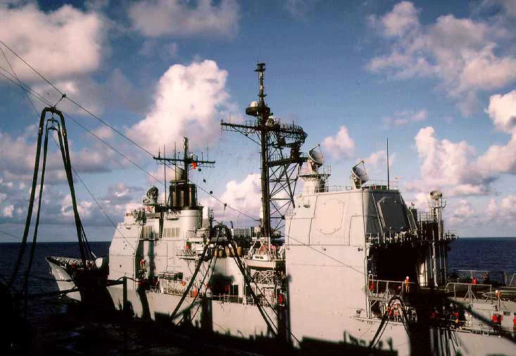 USS Detroit (AOE-4) resupplies the guided missile cruiser USS Normandy (CG-60). Atlantic Ocean, March 1990. Kodachrome 64.