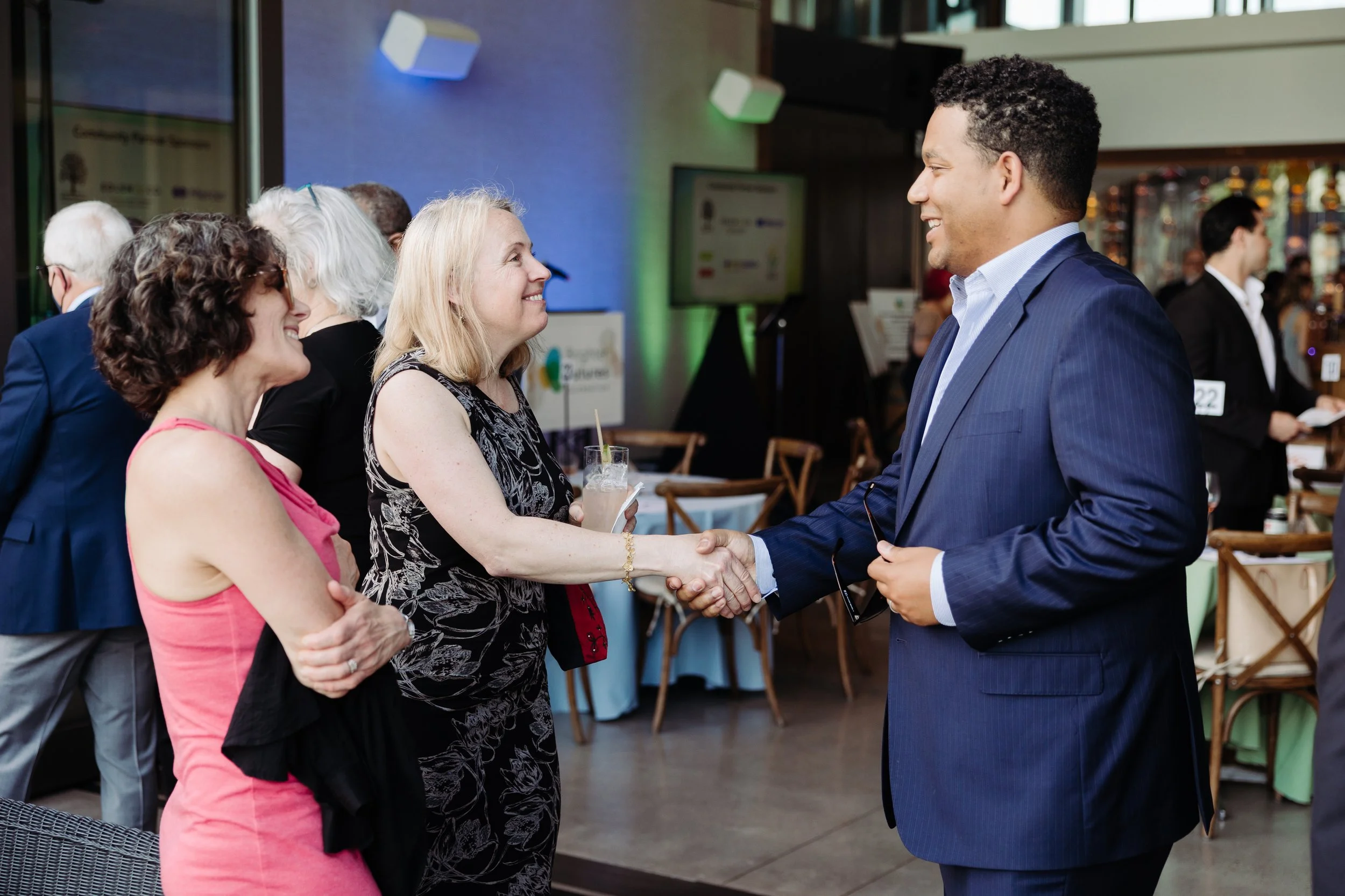 Two people shake hands at a corporate event in Portland Oregon