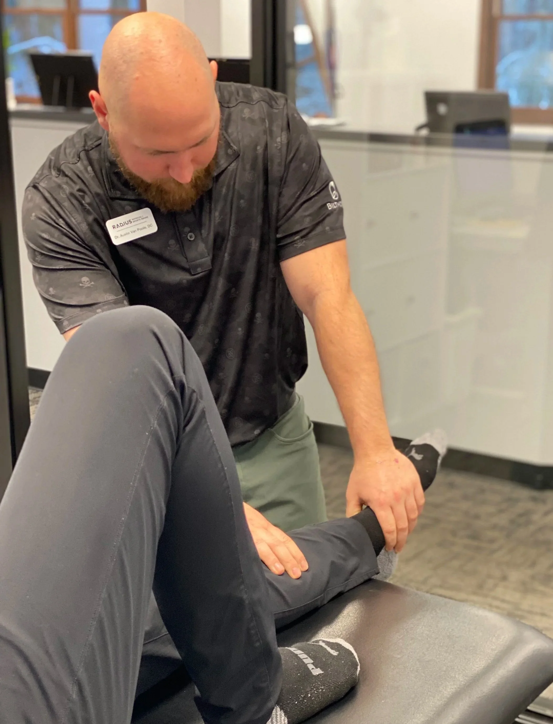 Provider performing knee and ankle joint mobilization during physical therapy treatment at Radius Physical + Sports Rehab in Nevada City, CA.