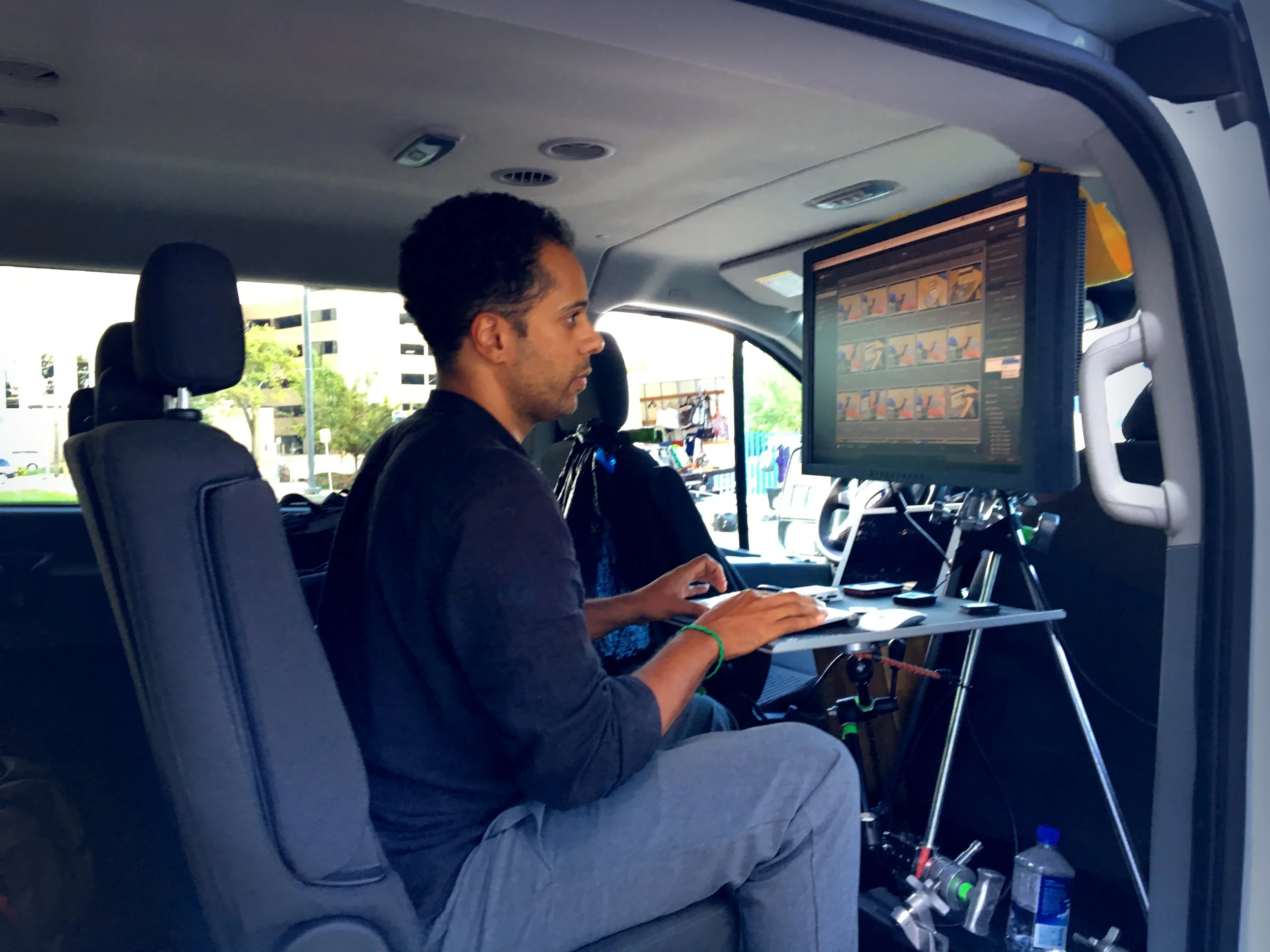 Digital Tech/First Assistant Demetrius Fordham downloading CF cards into Lightroom to a laptop in our digital mobile van. ©Doug Menuez using iPhone6s