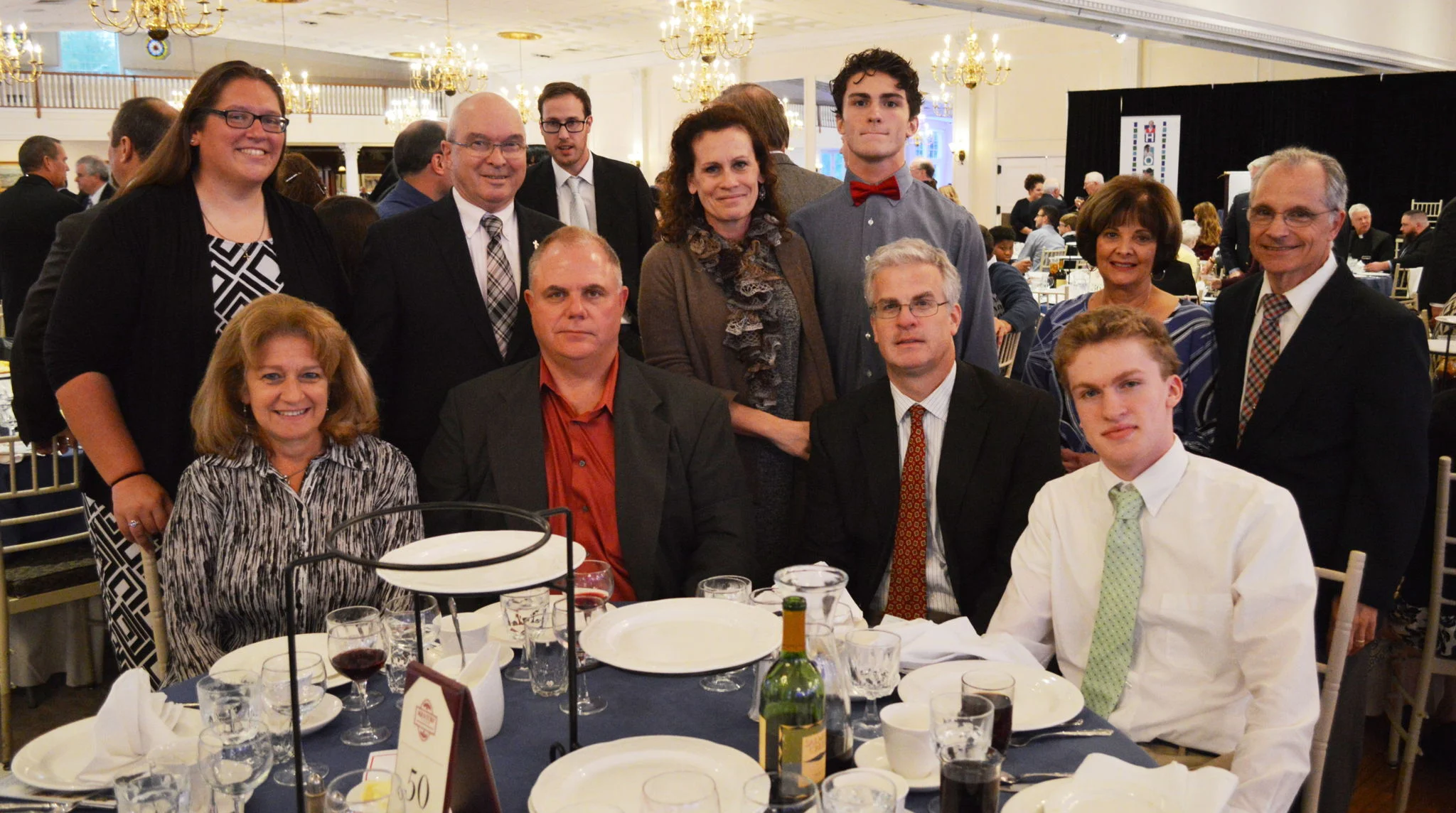 Seated is Linda Hart, St. John Neumann Award Recipient Tracy Hart, St. John Neumann Award Recipient Dennis Riordan, Ryan Riordan SMS '15. Standing Assistant Principal Liz Plasky, Deacon John Hoffman, Maureen Riordan, Tyler Riordan SMS '13, Arlene Lacerenza and Principal Frank Lacerenza. 