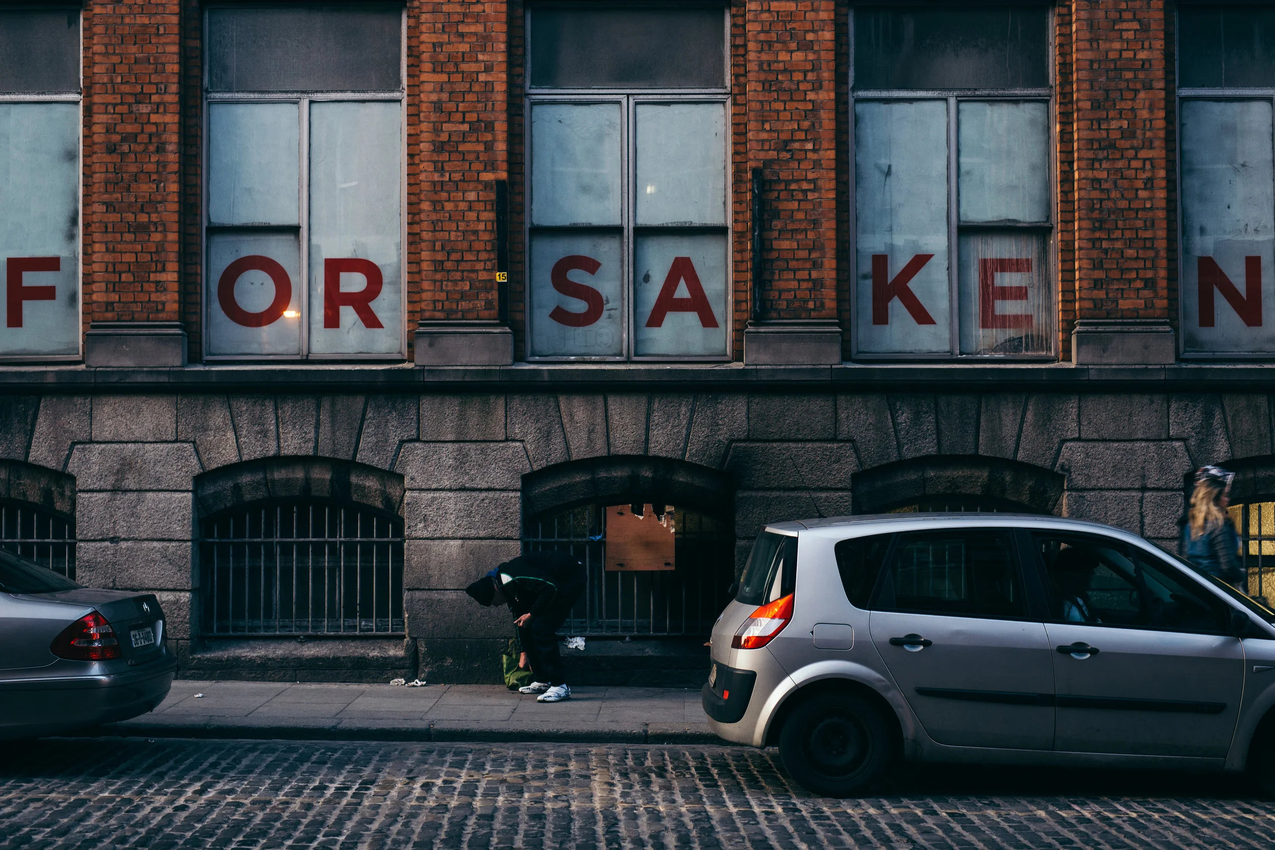 Homeless man bowed over in Dublin's Temple Bar. Photographer: Jack Farrell