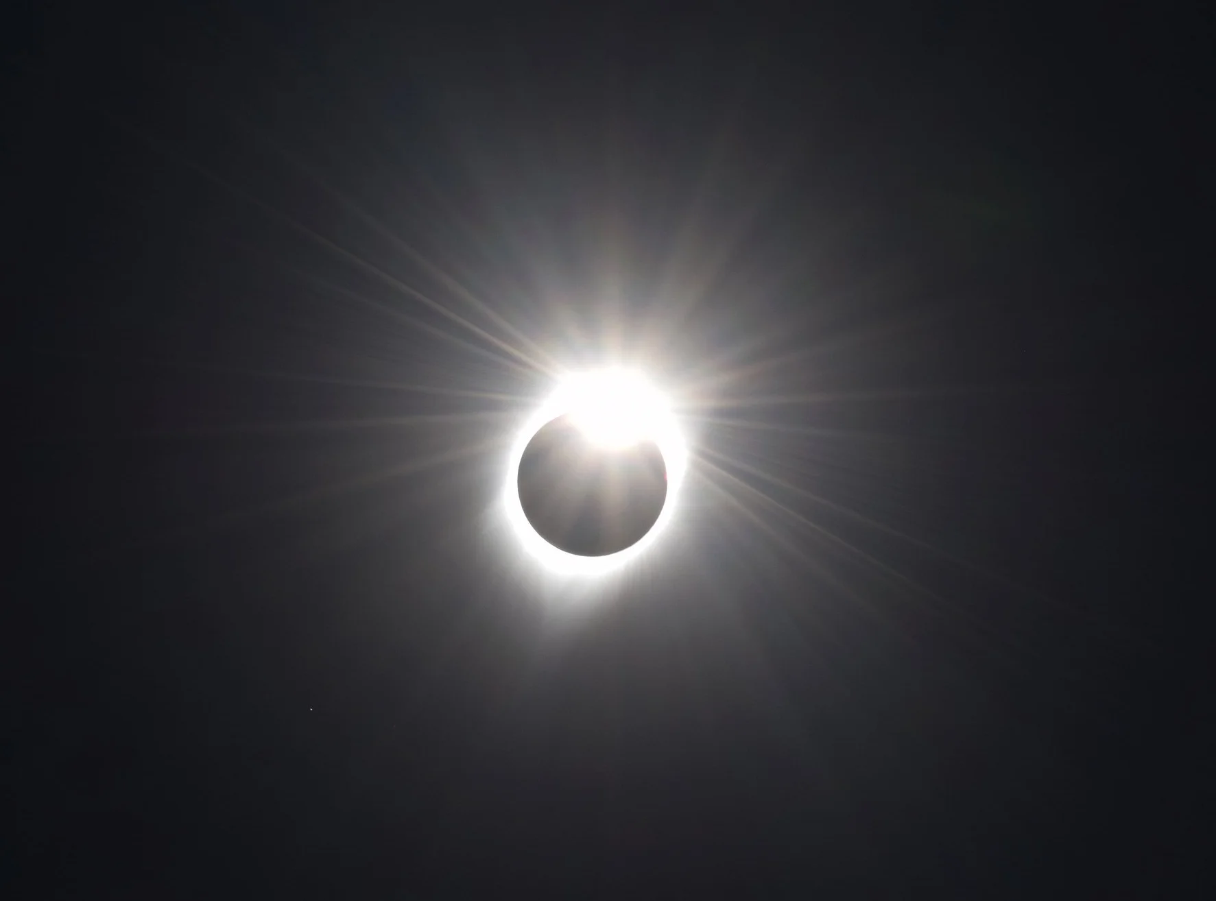 The "diamond ring" effect just after totality ends, and the moon moves on.