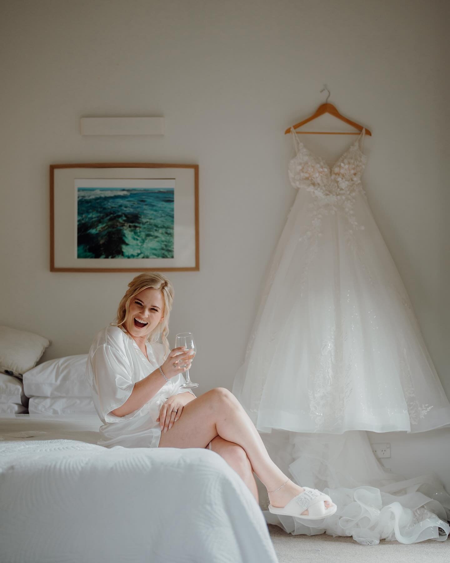 Zoe & Jaden | Tawharanui Lodge | Zoe's reaction says it all as she gets ready to get married to the man of her life! ✨ She's embracing this moment with excitement and joy—and a little bottle of gin attached to her bouquet, hehe. These price