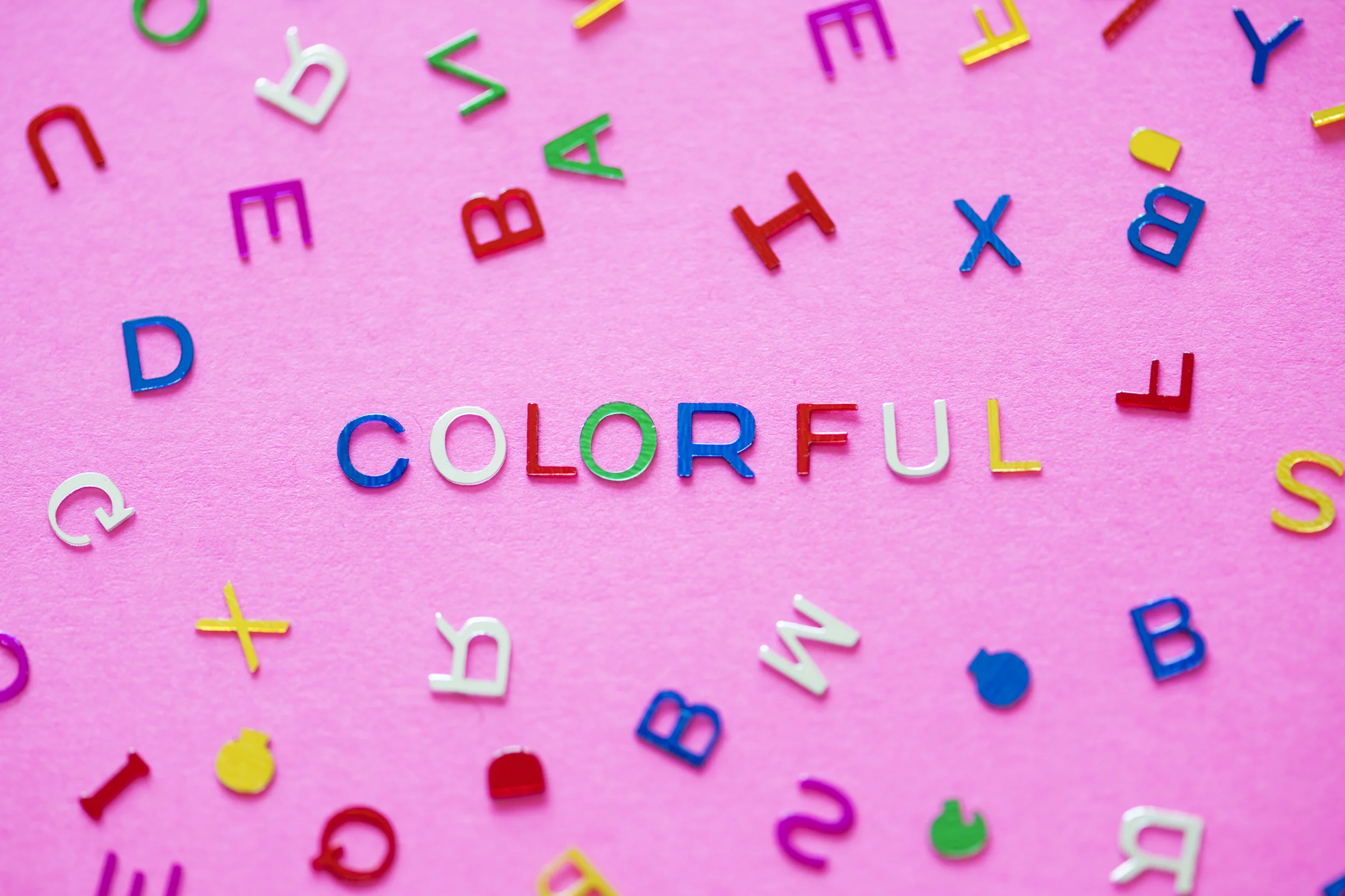 Colorful spelled word with alphabets background
