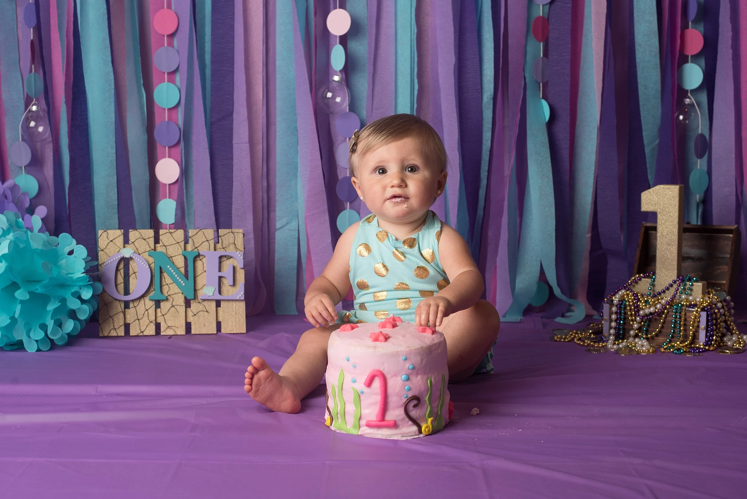 One year old girl eats her mermaid themed smash cake