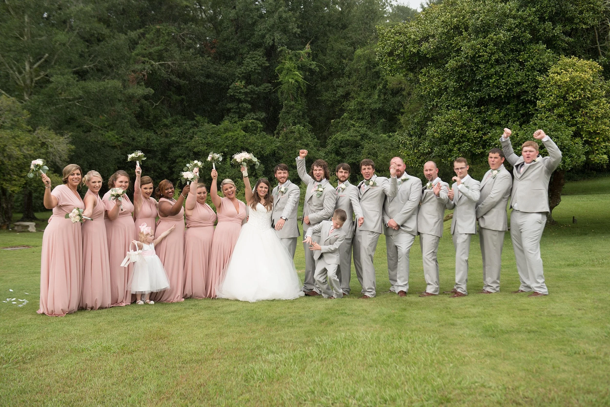 bridal party cheers for the bride and groom