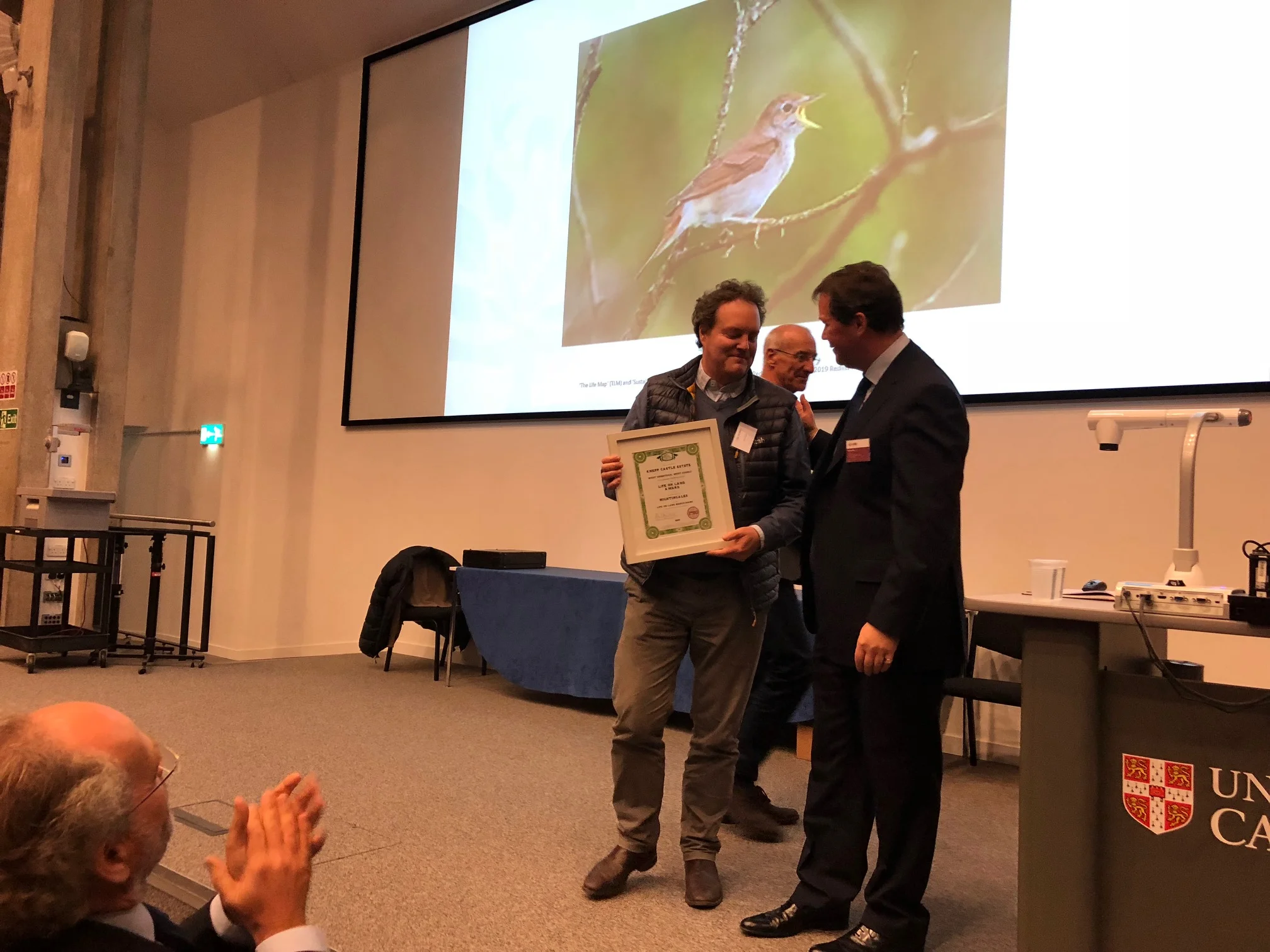 Jason collecting a prize from Cambridge University's CCI for Knepp's stunning nightingale recovery