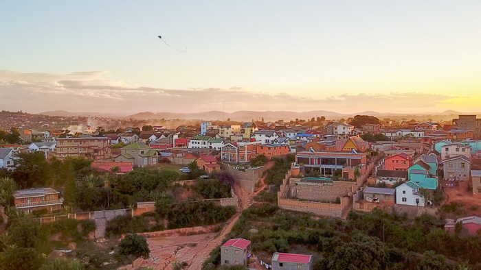 A kite flies over the capital Antananarivo at sunset