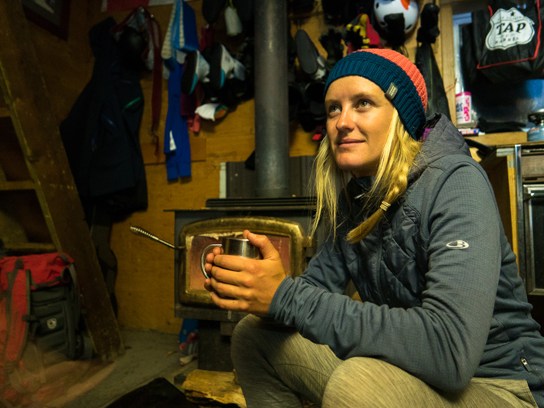 Soph enjoying the cosy hut by the fire. Photo: Pete Oswald