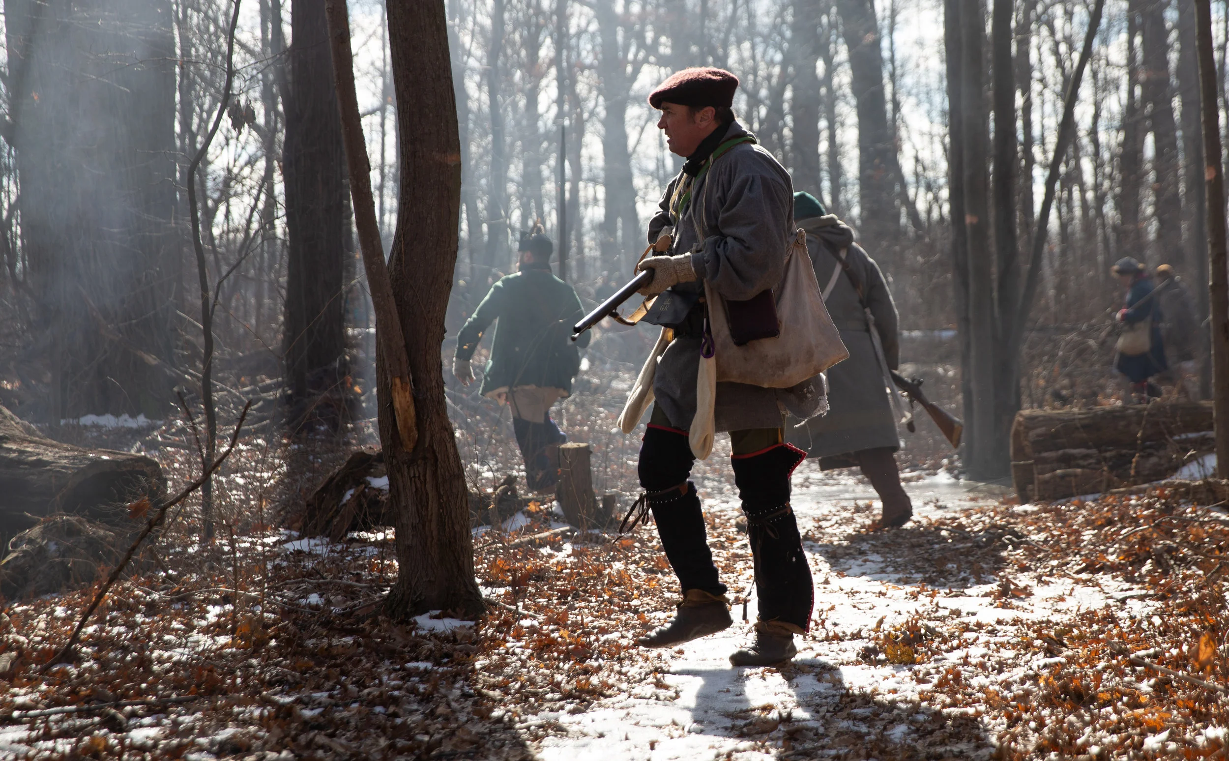  18th century British troops, played by historical reenactors, ambush a French garrison on patrol in the east woods along Lake Ontario during the "Winter Woods Battle" event near Fort Niagara in Youngstown, N.Y. on Feb. 16, 2019. 
