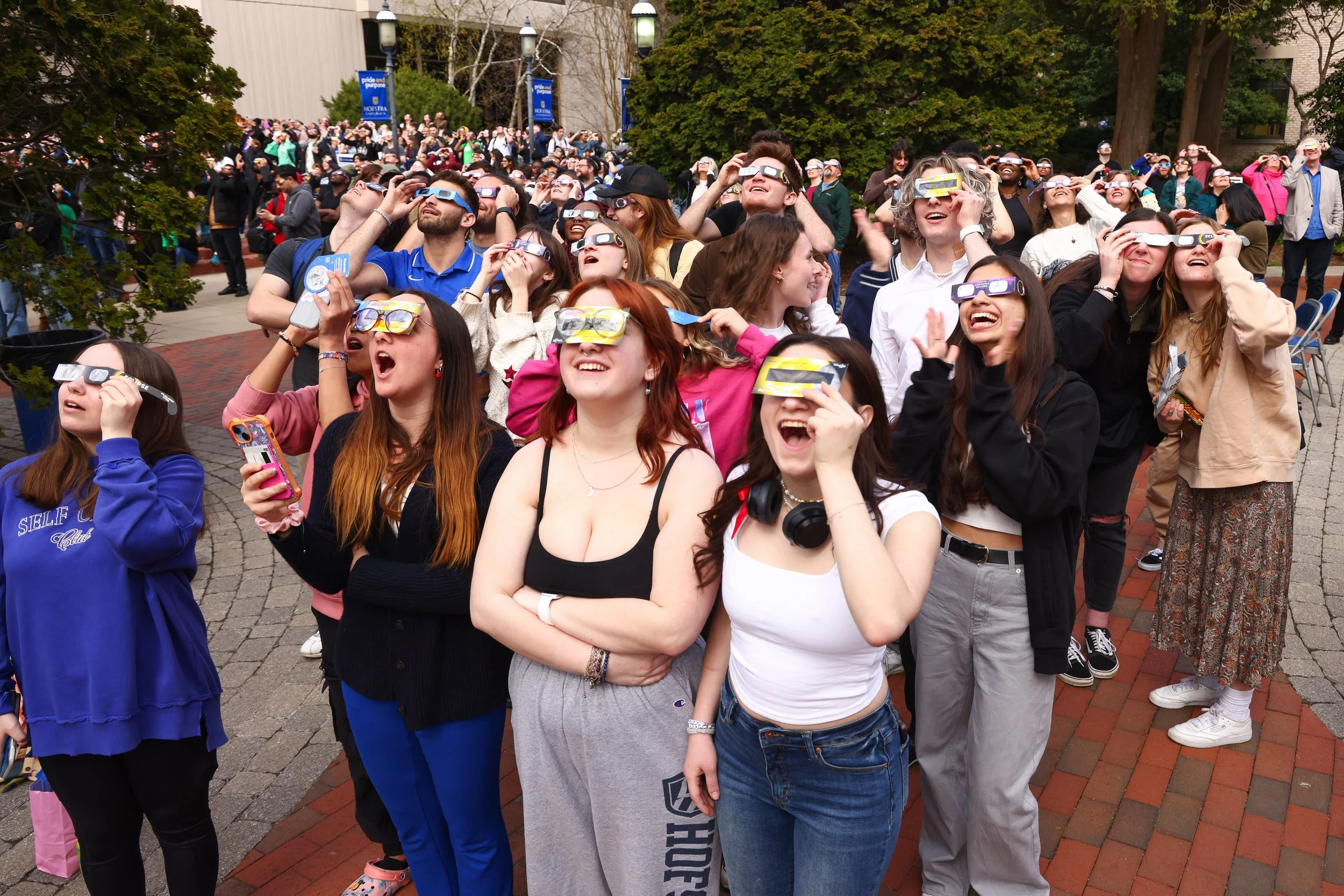  Students at Hofstra University take part in watching the total solar eclipse from their campus in Hempstead, N.Y. on April 8, 2024 