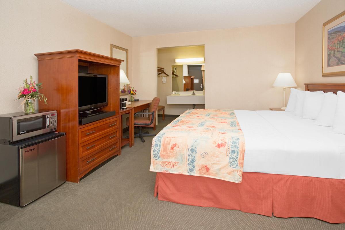 king bedroom at durango downtown inn with fridge, tv and microwave.jpg